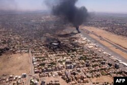 This image grab taken from AFPTV video footage on April 20, 2023, shows an aerial view of black smoke rising above the Khartoum International Airport amid ongoing battles between the forces of two rival generals.