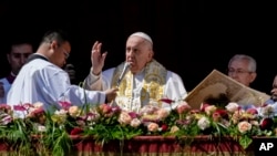 Pope Francis bestows the plenary 'Urbi et Orbi' (to the city and to the world) blessing from the central lodge of the St. Peter's Basilica at The Vatican at the end of the Easter Sunday Mass, April 9, 2023. 