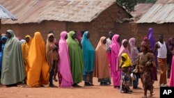 FILE - Parents wait for news about the kidnapped LEA Primary and Secondary School Kuriga students in Kuriga, Kaduna, Nigeria, on March 9, 2024.