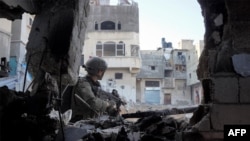 This handout picture released by the Israeli army on December 24, 2023 reportedly shows Israeli soldiers from the Givati Brigade operating in Khan Yunis in the southern Gaza Strip. (Photo by Israeli Army / AFP)