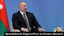 FILE - Azeri President Ilham Aliyev attends a meeting with Russian President Vladimir Putin in Astana, Kazakhstan, July 3, 2024. Aliyev pledged Saturday to help France's overseas territories secure independence.