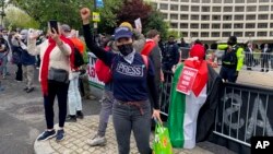 Demonstrators protest as guests arrive at the White House Correspondents' Association Dinner, April 27, 2024, in Washington.