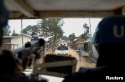 FILE - United Nations Organization Stabilization Mission in the Democratic Republic of the Congo (MONUSCO) peacekeepers patrol towards the Kigonze camp for the internally displaced people in Bunia, Ituri province of the Democratic Republic of Congo, March 2, 2023.