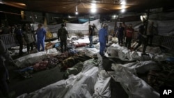 Bodies of Palestinians killed by an explosion at the Al-Ahli Arab hospital are seen gathered at Al-Shifa hospital, in Gaza City, central Gaza Strip, Oct. 17, 2023.
