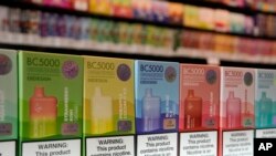 FILE - Varieties of disposable flavored electronic cigarette devices manufactured by EB Design, formerly known as Elf Bar, are displayed at a store in Pinecrest, Fla., June 26, 2023. 