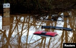 A car is submerged in flood water after heavy rain from Storm Henk, Worcester, Britain, Jan. 3, 2024.