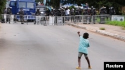 ក្មេង​ប្រុស​ម្នាក់​លើកដៃ​ដាក់​ប៉ូលិស ខណៈ​បាតុករ​ប្រមូល​ផ្តុំ​គ្នា​នៅ​តាម​ដងផ្លូវ​សម្រាប់​ថ្ងៃ​ទី​បី​នៃ​ការ​តវ៉ា​ប្រឆាំង​រដ្ឋាភិបាល​ក្នុង​ក្រុង Accra ប្រទេស​ហ្គាណា កាលពី​ថ្ងៃទី២៣ ខែកញ្ញា ឆ្នាំ២០២៣។