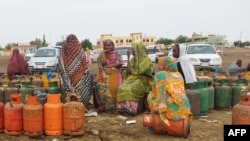 Sudanese wait for a gas truck to arrive to exchange their empty canisters, in Wad Madani, the capital of Sudan's al-Jazirah state, June 14, 2023. With fighting in Khartoum showing no signs of abating, small business owners are struggling to stay afloat.