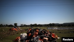 FILE - A pile of life jackets is seen on the island of Lesbos, Greece, Feb. 17, 2020. 