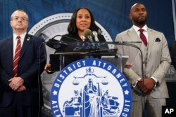 Fulton County District Attorney Fani Willis, center, speaks at the Fulton County Government Center during a news conference, in Atlanta, Georgia, Aug. 14, 2023. Donald Trump and several allies have been indicted in Georgia over efforts to overturn his 2020 election loss in the state. (AP Photo/John Bazemore)