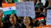 FILE — Members of the Kuki tribe protest the killing of tribals in their northeastern home state of Manipur, while they hold Indian flags and placards during a sit-in in New Delhi, India, May 29, 2023. 
