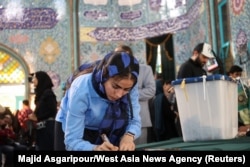 An Iranian woman votes at a polling station in Tehran, Iran, during a snap presidential election to choose a successor to Ebrahim Raisi following his death in a helicopter crash, June 28, 2024. (Majid Asgaripour/West Asia News Agency via Reuters)