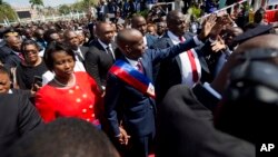 FILE - Haiti's President Jovenel Moise walks with his wife, Martine, to the National Palace after being sworn in, in Port-au-Prince, Haiti, Feb. 7, 2017.