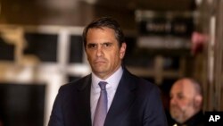 Former President Donald Trump's attorney Todd Blanche listens as his client speaks to the media as they exit the courtroom following proceedings in his trial, at Manhattan Criminal Court in New York, April 19, 2024.