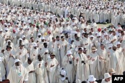 Priests pray as they attend the closing mass of the World Youth Days (WYD) in Tejo Park, Lisbon, Aug. 6, 2023.
