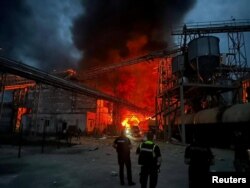 Rescuers work at the site of vegetable oil factory destroyed by Russian missile strike, amid Russia's attack on Ukraine, in Poltava region, Ukraine, Aug. 28, 2023. (Head of Ukraine's Presidential Office Andriy Yermak via Telegram/Handout via Reuters)