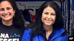 FILE - Samantha Woll, left, poses with Michigan Attorney General Dana Nessel on Sept. 4, 2022, in Royal Oak, Mich. Woll, who worked on Nessel’s 2022 campaign, was found stabbed to death outside her home in Detroit, Oct. 21, 2023. (Kimberly Bush via AP)