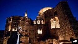 A Muslim cleric walks along a former Byzantine church which formally opened as a mosque, in Istanbul, Turkey, May 6, 2024. 