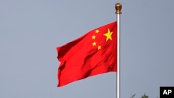 FILE - A Chinese national flag flies at Tiananmen Square in Beijing, June 14, 2018. China media announced on Dec. 20, 2023, that "zhen," meaning "self-inspire," was selected as the Chinese character of the year.