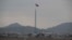 FILE - A North Korean flag flutters in North Korea's village Gijungdong as seen from an South Korea's observation post inside the demilitarized zone in Paju, South Korea, during a media tour, March 3, 2023.