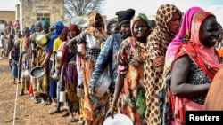 Women who fled the war-torn Sudan queue to receive food rations at the United Nations High Commissioner for Refugees (UNHCR) transit centre in Renk, near the border crossing point in Renk County of Upper Nile State, South Sudan May 1, 2023. 