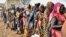 Women who fled the war-torn Sudan queue to receive food rations at the United Nations High Commissioner for Refugees (UNHCR) transit centre in Renk, near the border crossing point in Renk County of Upper Nile State, South Sudan May 1, 2023. 