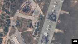 This image shows an overview of destroyed MiG-31 fighter aircraft and a fuel storage facility at Belbek air base, near Sevastopol, in Crimea, May 16, 2024. (Maxar Technologies via AP)