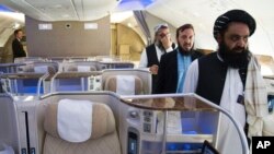 FILE - Badruddin Haqqani, right, then the Afghan Taliban envoy to the United Arab Emirates, walks through an aircraft displayed at the Dubai Air Show in the UAE, Nov. 13, 2023. The UAE on Aug. 21, 2024, accepted Haqqani's credentials as ambassador.