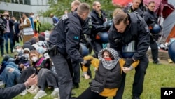 A protester is dragged away by police officers during a pro-Palestinians demonstration on the campus of Berlin's Free University, in Berlin, Germany, May 7, 2024.