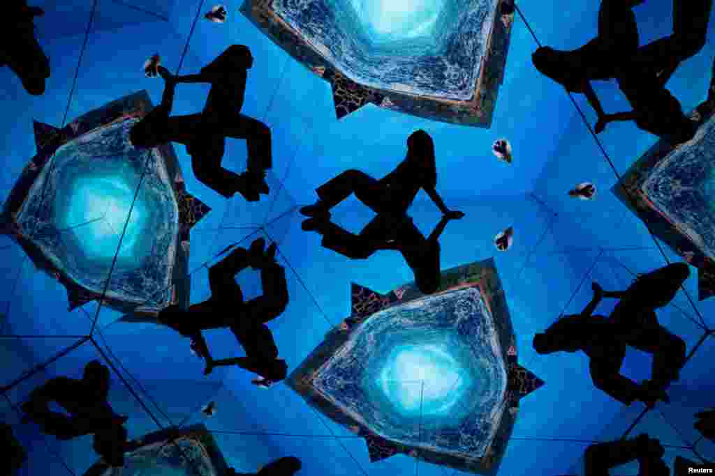 A woman interacts with visual art during a media presentation of the new Museo de la Luz (Museum of Light), before its inauguration in Madrid, Spain, March 20, 2024. 