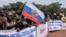 A demonstrator holds a Russian national flag during a rally in support of Russia's and China's presence in the Central African Republic, in the capital Bangui, March 22, 2023.