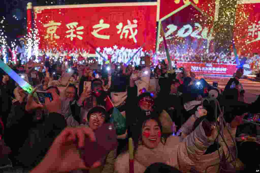 Revelers ring in the new year after a countdown to 2024 in Beijing, China, Jan. 1, 2024.