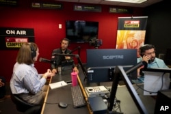 From left, guest Carolina Rodriguez-Greer with Mi Familia Vota, host Osvaldo Franco and engineer Daniel Orona broadcast from the Phoenix studio of Radio Campesina, a Spanish-language network, March 20, 2024.