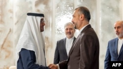 This handout image provided by the UAE's Presidential Court shows UAE's President Sheikh Mohamed bin Zayed al-Nahyan, left, meeting with Iran's Foreign Minister Hossein Amir-Abdollahian in Abu Dhabi on June 22, 2023. 