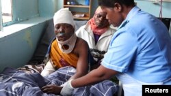 FILE — A nurse treats a flood victim in Queen Elizabeth Central hospital in Blantyre, Malawi, March 16, 2023. In Malawi, thousands of unemployed nurses are urging the government to help them find work.