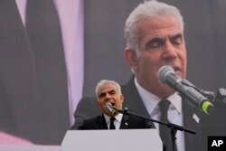 Pemimpin oposisi Israel dan mantan Perdana Menteri Yair Lapid berbicara selama rapat umum menentang rencana pemerintah baru PM Benjamin Netanyahu untuk merombak sistem peradilan, di luar Knesset, parlemen Israel, di Yerusalem, Senin, 13 Februari 2023. (AP/Ohad Zwigenberg)