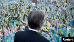 U.S. Secretary of State Antony Blinken pays his respects to fallen Ukrainian soldiers at a makeshift memorial in Kyiv, Ukraine, May 14, 2024.
