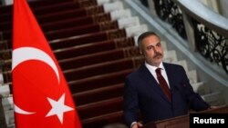 FILE - Turkish Foreign Minister Hakan Fidan attends a press conference at Tahrir Palace in Cairo, Egypt, Aug. 5, 2024. He'll meet with counterparts from Russia and Iran this weekend to discuss the rebel offensive in Syria.