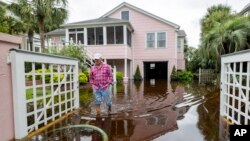 Robert Chesnut walks through water at his Palm Blvd. home after it was flooded by Tropical Storm Debby, Aug. 8, 2024, in Isle of Palms, South Carolina.