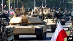U.S.-made Abrams tanks purchased by Poland take part in a massive military parade to celebrate the Polish Army Day, commemorating the 1920 battle in which Polish troops defeated advancing Bolshevik forces, in Warsaw, Poland, Aug. 15, 2023.