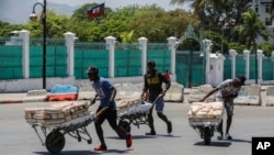 Para pedagang kaki lima melarikan diri dari area tempat mereka berjualan roti, dekat Istana Nasional, di Port-au-Prince, Haiti, Selasa, 2 April 2024. (Foto: Odelyn Joseph/AP Photo)