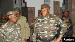 FILE - General Abdourahmane Tiani, who was declared the new head of state of Niger by leaders of a coup, arrives to meet with ministers in Niamey, Niger, July 28, 2023. 