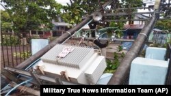 A lamppost attached with electrical transformer is seen damaged by Cyclone Mocha lines on a street in Gwa township, Rakhine State, May 14, 2023.