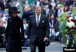 Dutch King Willem-Alexander, right, and Queen Maxima attend the annual World War II remembrance ceremony in Amsterdam, Netherlands, May 4, 2024.