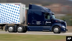 A self-driving tractor-trailer maneuvers around a test track in Pittsburgh, Thursday, March 14, 2024. (AP Photo/Gene J. Puskar)