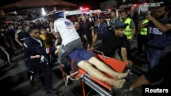 An injured person is assisted at Shifa Hospital after an Israeli air strike hit the nearby Al-Ahli Hospital, according to Gaza Health Ministry, in Gaza City, Gaza Strip, Oct. 17, 2023.