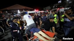 An injured person is assisted at Shifa Hospital after an explosion hit the nearby Al-Ahli Hospital, according to Gaza Health Ministry, in Gaza City, Gaza Strip, Oct. 17, 2023.