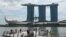 People take pictures on the jetty at Marina Bay waterfront in Singapore, Nov. 17, 2023.