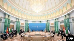 In this handout photograph released by Kazakhstan's presidential press service, Kazakhstan's President Kassym-Jomart Tokayev, center, speaks at a Heads of State of Central Asia Summit session in Astana on Aug. 9, 2024. 