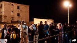 Sudanese evacuees wait before boarding a Saudi military ship to Jeddah port, at Port Sudan in Sudan, Wednesday, May 3, 2023. Many are fleeing the conflict in Sudan between the military and a rival paramilitary force.